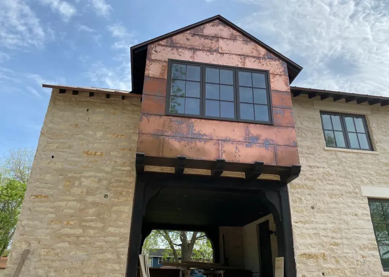 Copper metal panel facade on a stone building for Metal Roof Coating in Busti